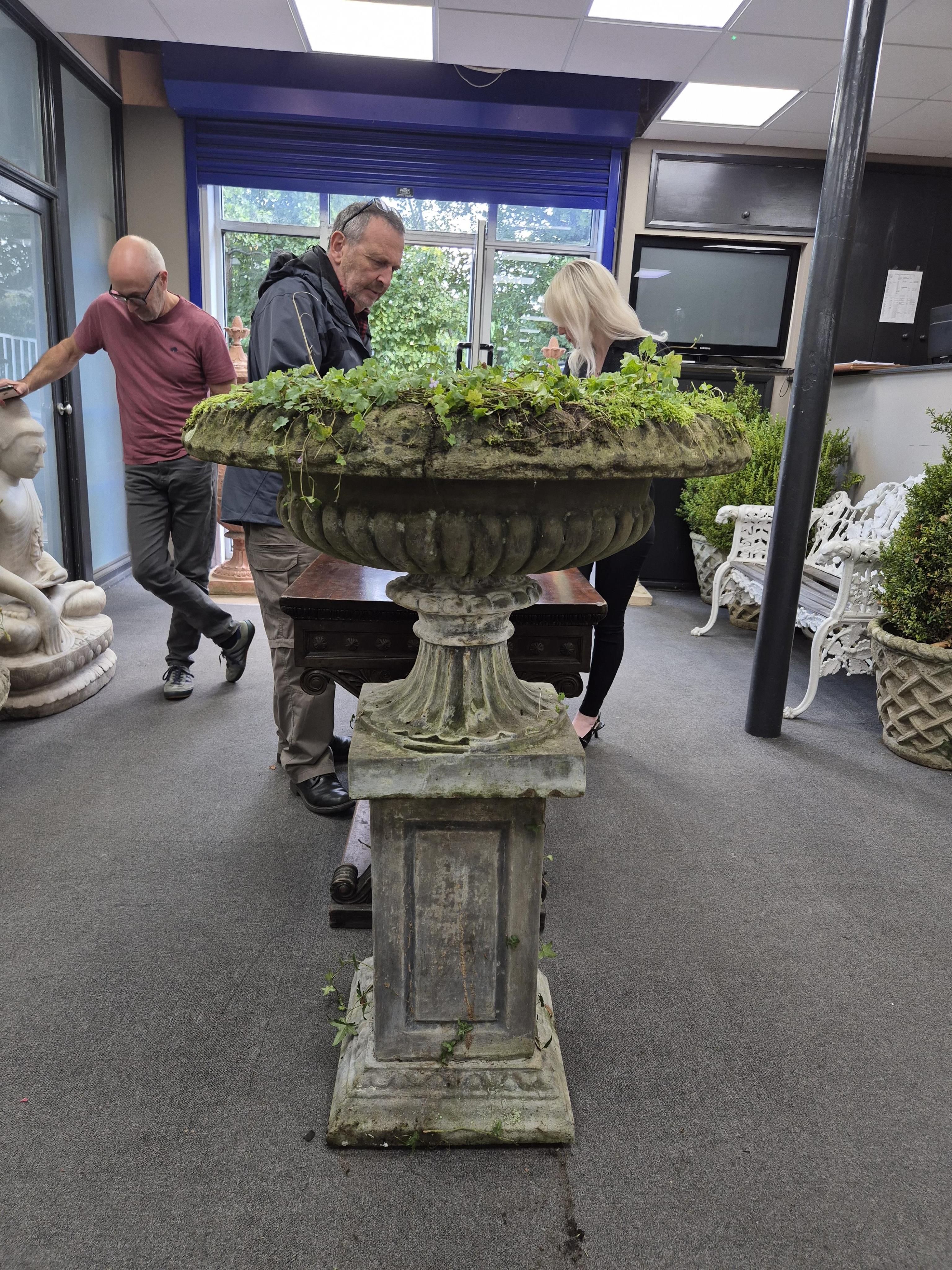 A large reconstituted stone garden vase